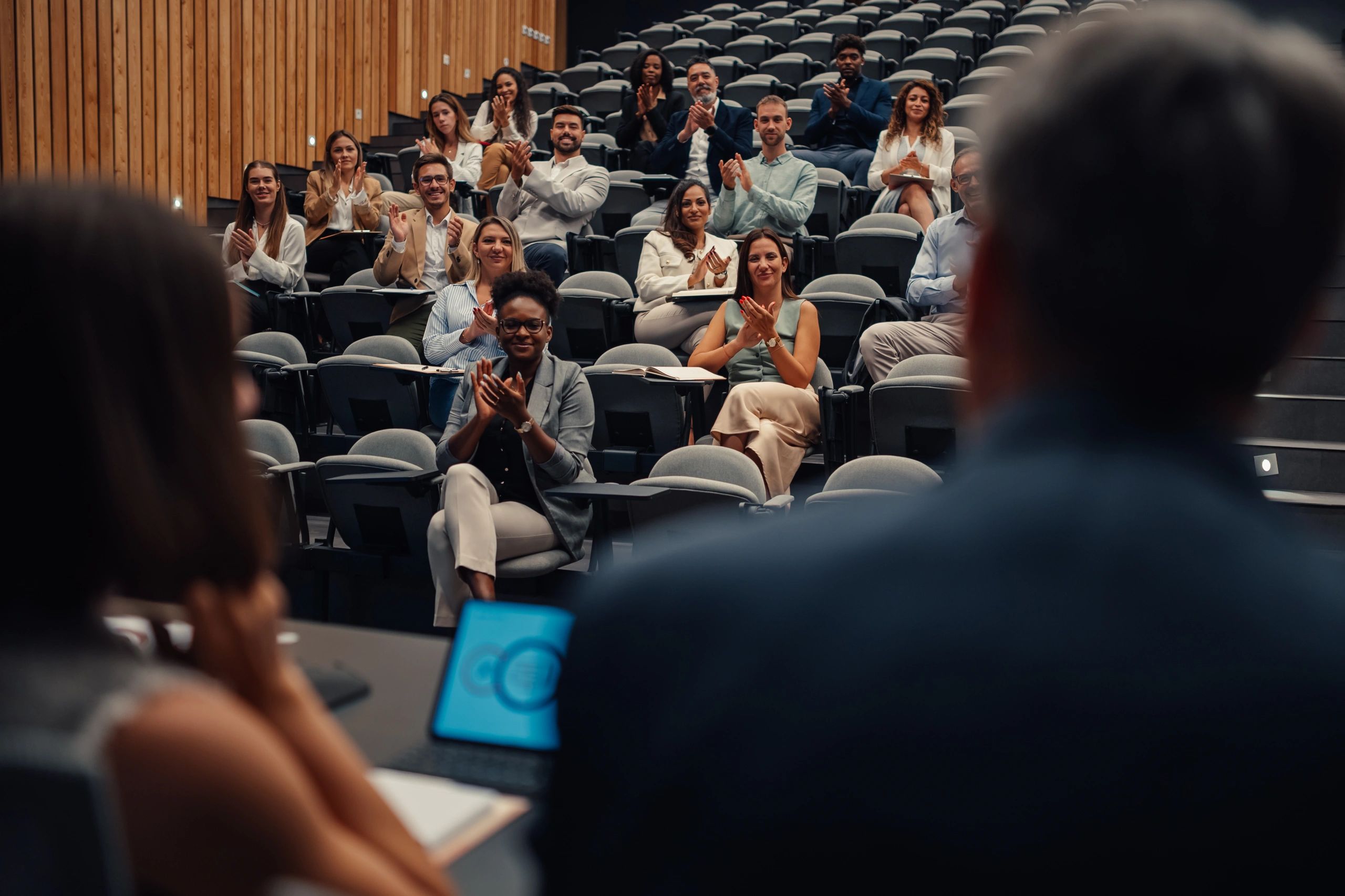 Business audience applauding during a professional presentation